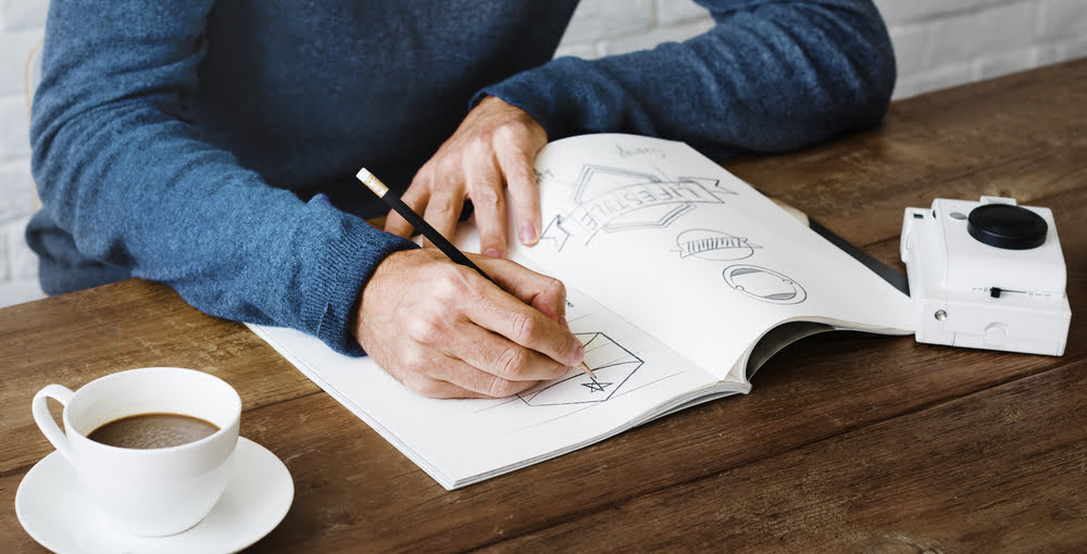 Man Drawing Business Logos for Branding and Marketing